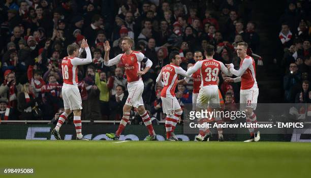 Arsenal's Per Mertesacker celebrates with his team mates after he scores their side's first goal of the game