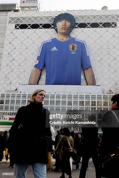 Pedestrians walk in front of a huge balloon depicting Japanese soccer player, Shunsuke Nakamura, wearing a team shirt for this summers 2002...