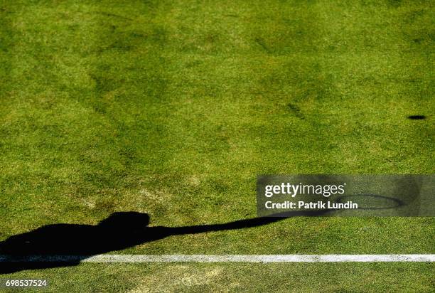 The shadow of Andy Murray is pictured as he serves during the mens singles first round match against Jordan Thompson of Australia on day two of the...