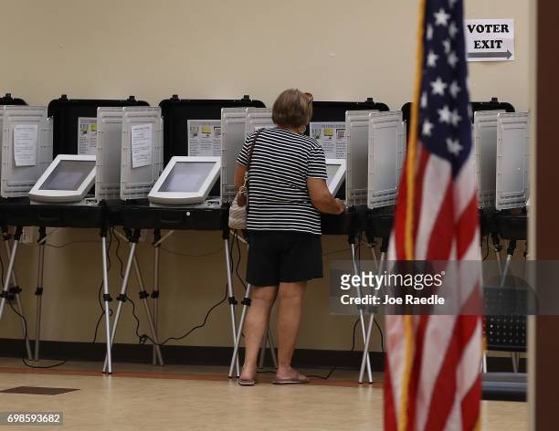 Woman casts her ballot during a special election in Georgia's 6th Congressional District special election at North Fulton Government Service Center...