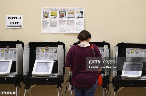 Woman casts her ballot during a special election in Georgia's 6th Congressional District special election at North Fulton Government Service Center...