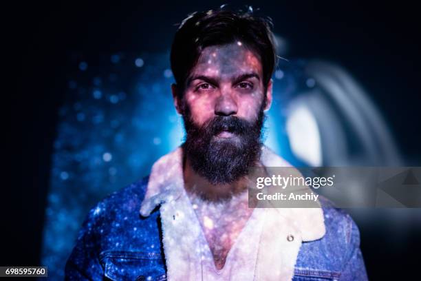 stars and sky image projected on a bearded man's upper boddy. - face projection stock pictures, royalty-free photos & images