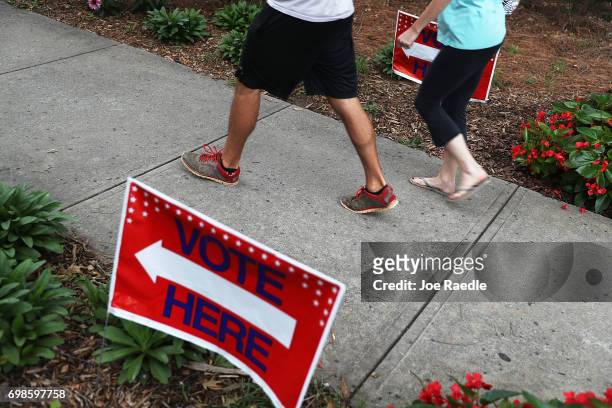 People walk to a polling place as ballots are cast during a special election in Georgia's 6th Congressional District at North Fulton Government...
