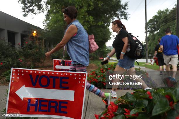 People walk to a polling place as ballots are cast during a special election in Georgia's 6th Congressional District at North Fulton Government...