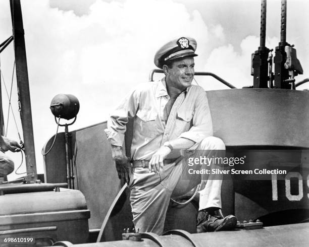 American actor Cliff Robertson plays John F. Kennedy as a young Navy Lieutenant on a Motor Torpedo Boat in the film 'PT 109', 1963.