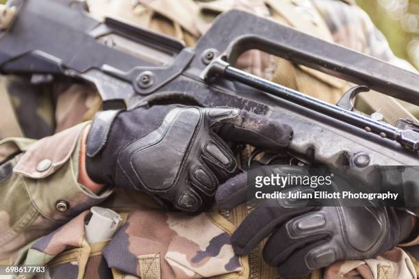 a soldier holds his gun. - personal militar fotografías e imágenes de stock