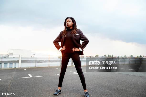 young girl standing in parking lot - breitbeinig stehen stock-fotos und bilder