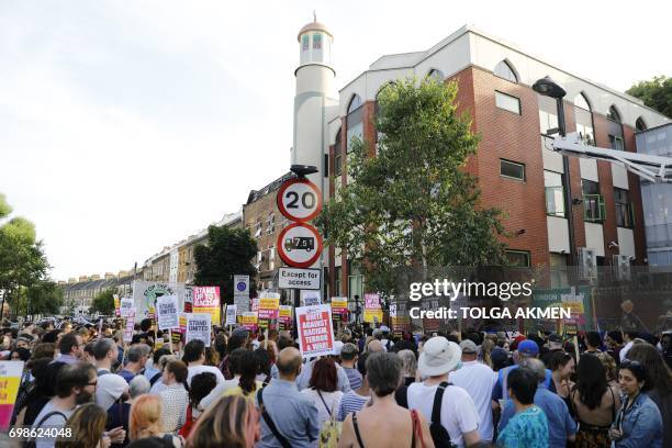 People attend a vigil outside Finsbury Park Mosque in north London on June 20 following a van attack on pedestrians nearby on June 19. Ten people...