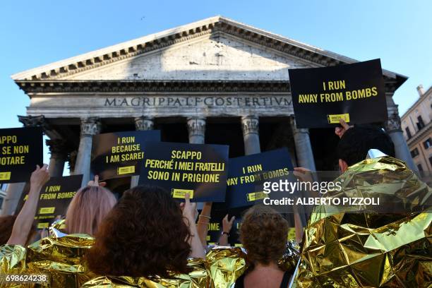 Activists of human rights organization Amnesty International gather in front of the Pantheon during a flashmob on World Refugee Day, in central Rome...
