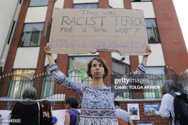 People attend a vigil outside Finsbury Park Mosque in north London on June 20 following a van attack on pedestrians nearby on June 19. Ten people...
