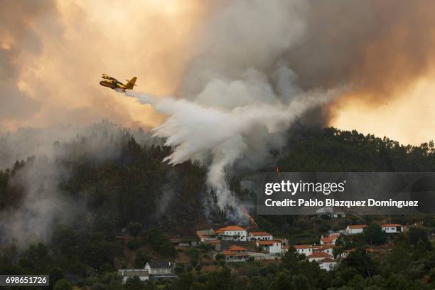 Firefighter plane battles a fire after a wildfire took dozens of lives on June 20, 2017 in Mega Fundeira village, near Picha, in Leiria district,...