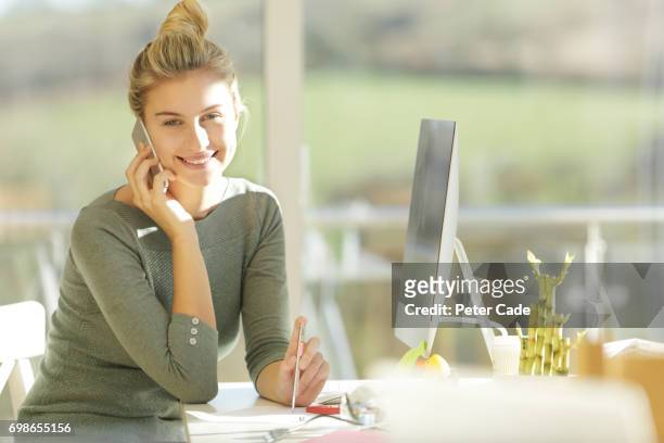 woman sat in modern office talking on phone - sattel bildbanksfoton och bilder