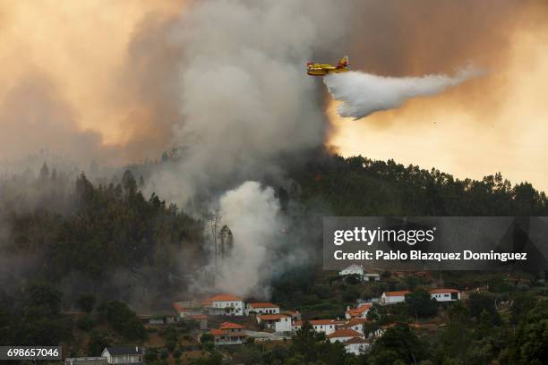 Firefighter plane battles a fire after a wildfire took dozens of lives on June 20, 2017 in Mega Fundeira village, near Picha, in Leiria district,...