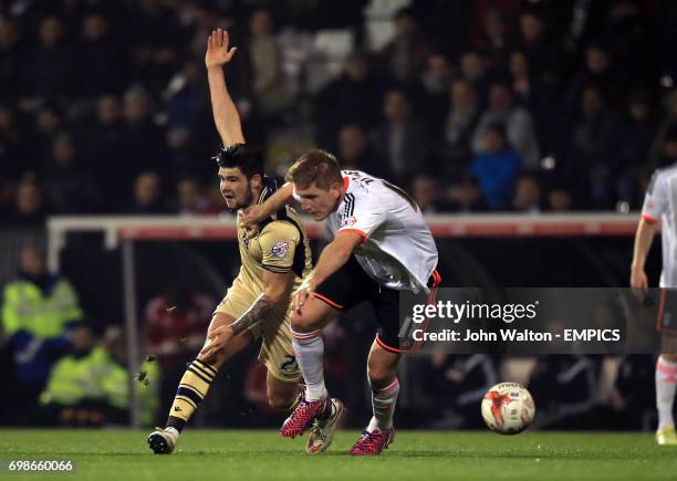 Fulham's Michael Turner, battles for possession of the ball with Leeds United's Charlie Taylor,