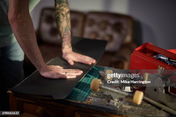 close up of male pressing grip tape to skateboard - toolbox stock pictures, royalty-free photos & images