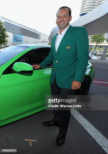 Sergio Garcia of Spain arrives in his green jacket as he shows off his chipping skills at the pro-am prize giving at BMW Welt ahead of the BMW...