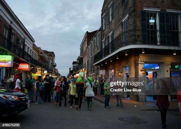people walking in bourbon street, new orleans - great new orleans bridge stock pictures, royalty-free photos & images