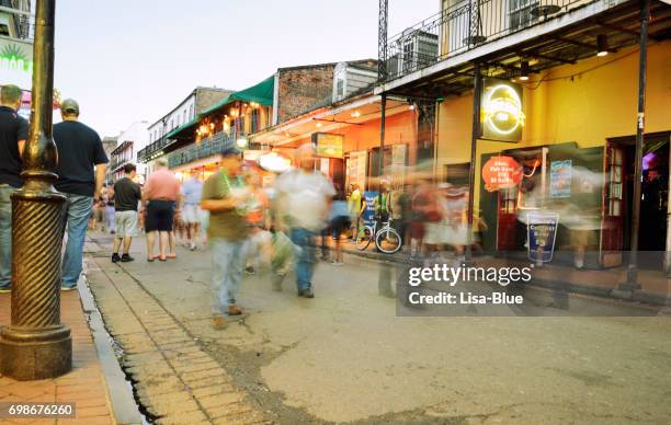 people walking in bourbon street, new orleans - great new orleans bridge stock pictures, royalty-free photos & images