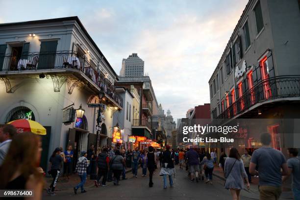 people walking in bourbon street, new orleans - great new orleans bridge stock pictures, royalty-free photos & images