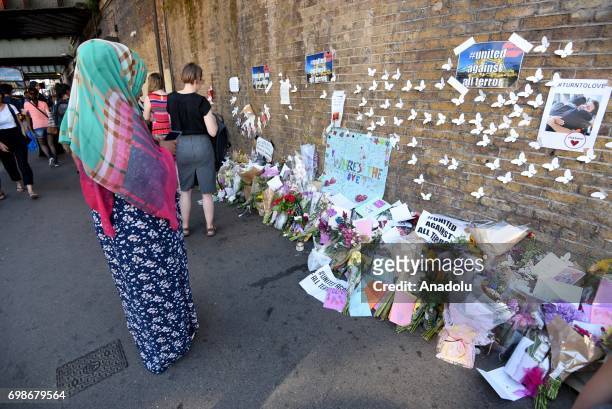People lay flowers outside Finsbury Park Mosque in London, England on June 20, 2017. Worshippers were struck by a hired van as they were leaving...