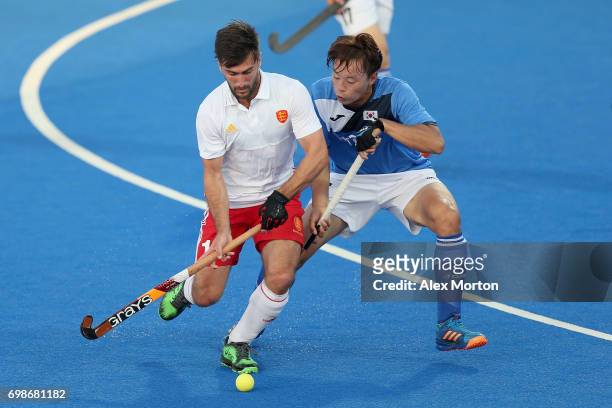 Adam Dixon of England and Daeyeol Lee of South Korea battle for the ball during the Pool A match between England and South Korea on day six of the...
