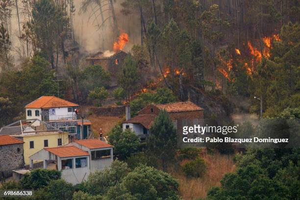 House burns as a wildfire approaches Mega Fundeira village after a wildfire took dozens of lives on June 20, 2017 near Picha, in Leiria district,...