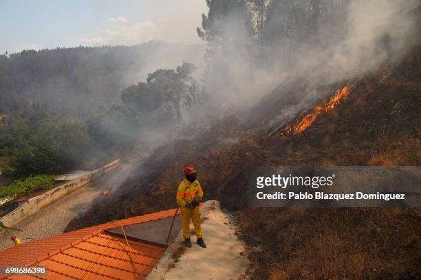 Firefighter watches flames approaching Mega Fundeira village after a wildfire took dozens of lives on June 20, 2017 near Picha, in Leiria district,...