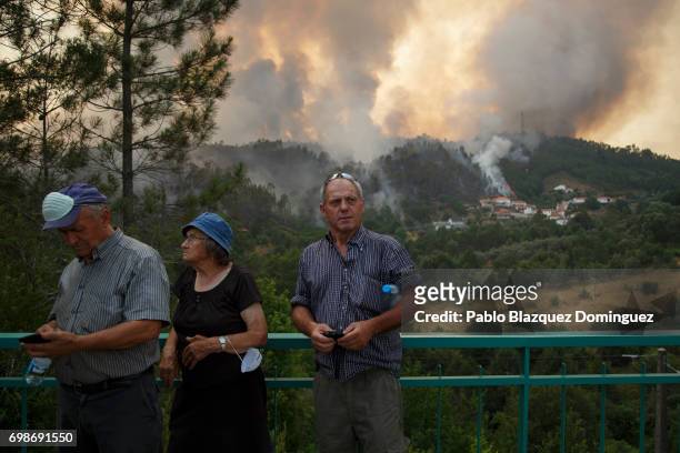 Local people watch how flames approach to Mega Fundeira village after a wildfire took dozens of lives on June 20, 2017 near Picha, in Leiria...