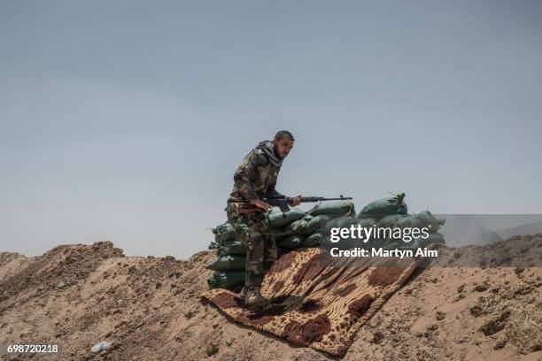 An Iraqi PMF fighter June 20, 2017 on the Iraq-Syria border in Nineveh, Iraq. The Popular Mobilisation Front forces, composed of majority Shi'ite...