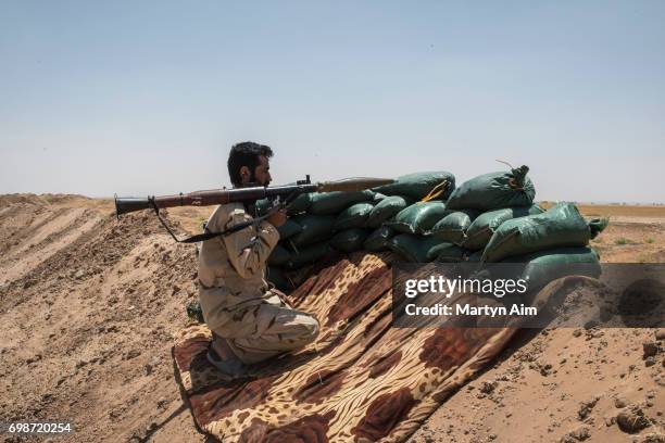 An Iraqi PMF fighter holding an RPG June 20, 2017 on the Iraq-Syria border in Nineveh, Iraq. The Popular Mobilisation Front forces, composed of...