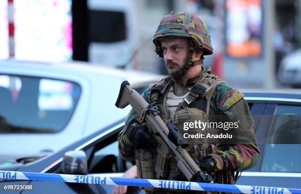 An armed soldier stands guard outside of the Brussels Central Station after a neutralized terrorist attack attempt, in Brussels, Belgium, 20 June...