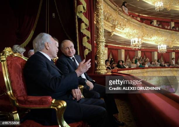 Russian President Vladimir Putin and Brazil's President Michel Temer speak as they attend the concert by the winners of the XIII International Ballet...