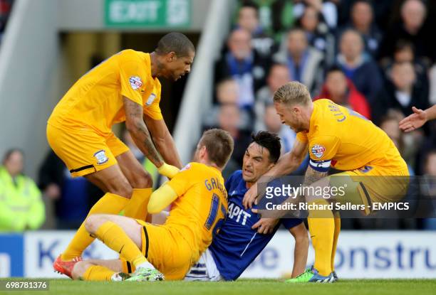 Chesterfield's Gary Roberts is pounced upon by Preston North End's Jermaine Beckford & Preston's Tom Clarke after he fouls Preston's Paul Gallagher