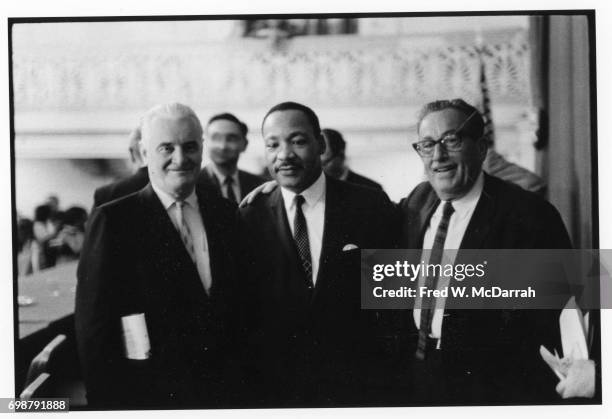 American labor leader Harry van Arsdale Jr and Civil Rights and Religious leader Reverend Martin Luther King Jr pose with an unidentified man...