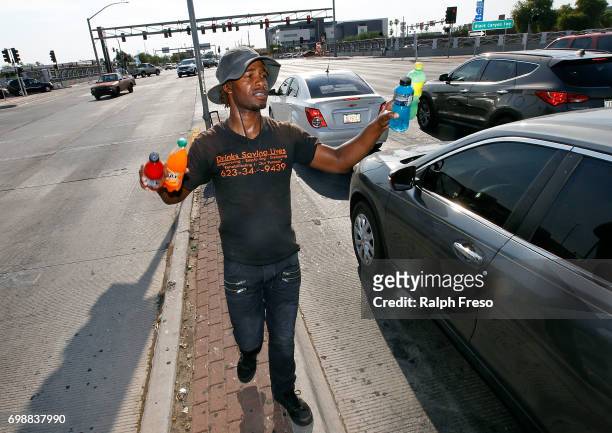 Thirty-three year old Eric Maurice Clark sells cold bottled drinks to motorist at a busy intersection on June 20, 2017 in Phoenix, Arizona. Record...