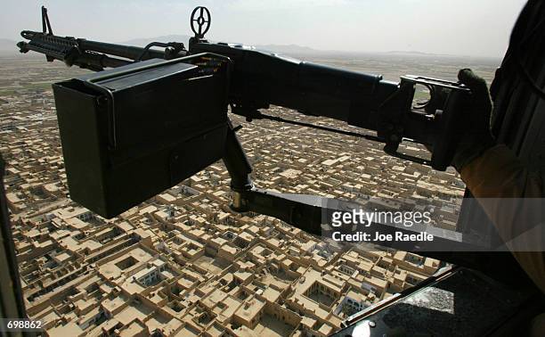 Army 101st Airborne Sgt. Jason Deer from Franklinville, New York flies over the city of Kandahar in a Blackhawk helicopter as he mans his M-60 Delta...