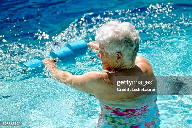 senior woman excersicing - water aerobics stock pictures, royalty-free photos & images