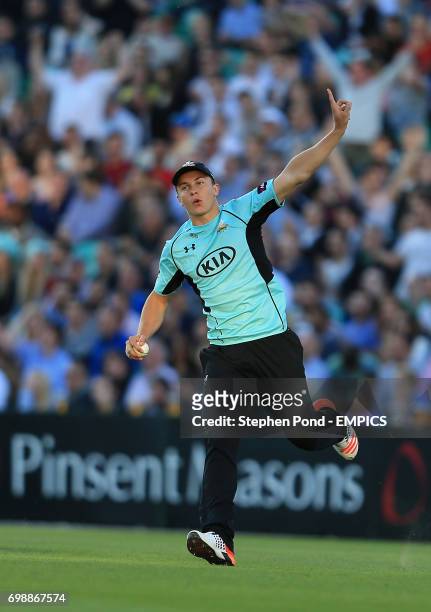 Surrey's Tom Curran celebrates catching out Essex's Alastair Cook