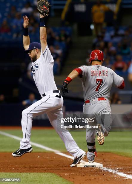 First baseman Trevor Plouffe of the Tampa Bay Rays gets the out at first base on Eugenio Suarez of the Cincinnati Reds to end the top of the fifth...