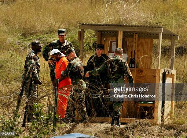 Detainee is taken from a questioning session at camp X-Ray February 6, 2002 in Guantanamo Bay, Cuba. The 156 Al Qaeda and Taliban prisoners are...