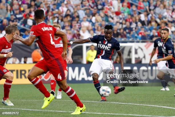 New England Revolution midfielder Gershon Koffie takes a shot at the top of the box during a regular season MLS match between the New England...