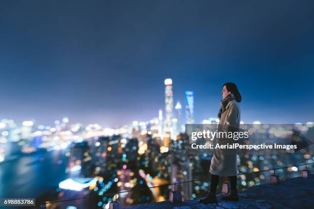 woman overlooking the stunning city of shanghai - shanghai city life stock pictures, royalty-free photos & images