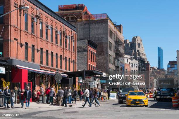 rows of buildings along gansevoort street and people at meatpacking district west village manhattan new york city. - west village foto e immagini stock