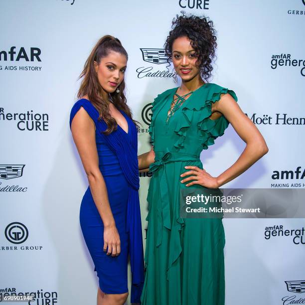 Miss Universe 2016 Iris Mittenaere and Miss USA 2017 Kara McCullough attend amfAR generationCURE Solstice 2017 at Mr. Purple on June 20, 2017 in New...