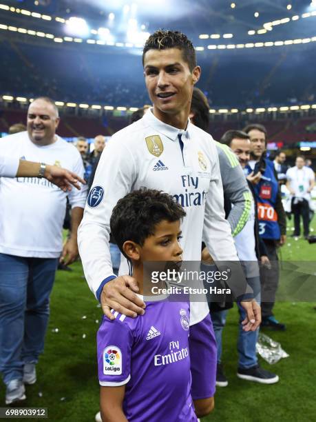 Cristiano Ronaldo of Real Madrid walks his son after the UEFA Champions League final match between Juventus and Real Madrid at National Stadium of...