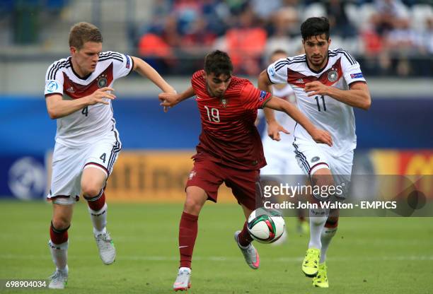 Portugal's Ricardo Horta battles for the ball with Germany's Matthias Ginter and Emre Can