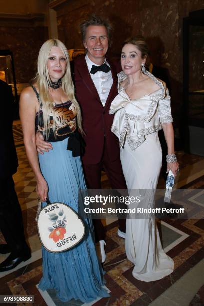 Member of "Duran Duran" John Taylor standing between his wife Gela and Becca Cason Thrash attend the "Liaisons au Louvre IV" - Evening of patronage...