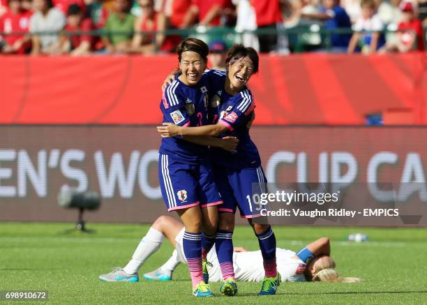 Japan's Azusa Iwashimizu and Saori Ariyoshi celebrate at the final whistle as England's Steph Houghton collapses onto the pitch following the FIFA...