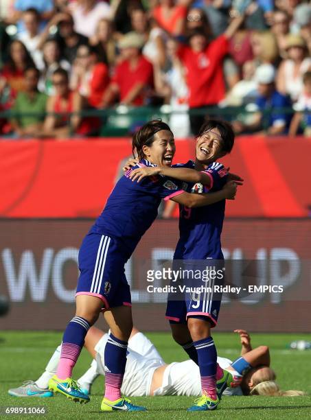 Japan's Azusa Iwashimizu and Saori Ariyoshi celebrate at the final whistle as England's Steph Houghton collapses onto the pitch following the FIFA...