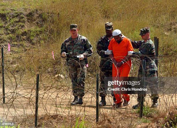 Marines transport a detainee in Camp X-Ray February 6, 2002 in Guantanamo Bay, Cuba. Many of the 156 Al-Qaeda or Taliban detainees are transported...